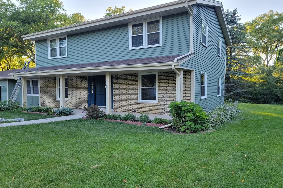 Home with two-tone green exterior paint