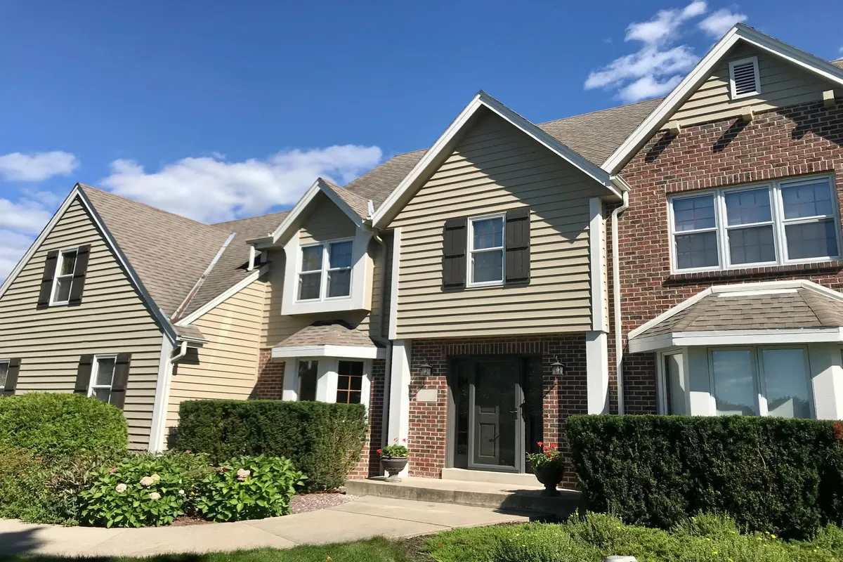 Multi story home with tan exterior paint
