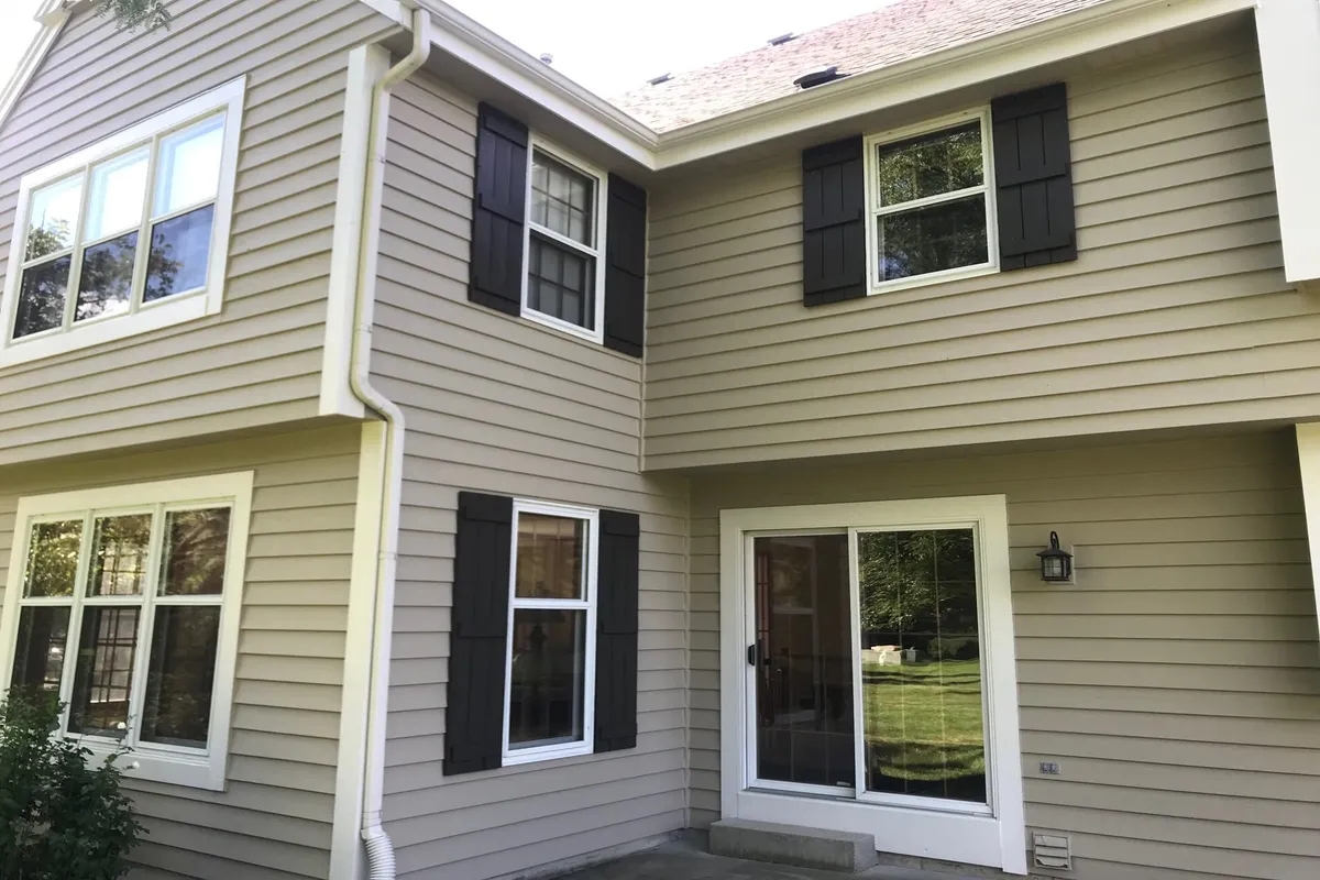 Two-story home with fresh tan exterior paint